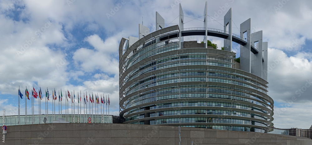 modern architecture of european union parliament with flags of members