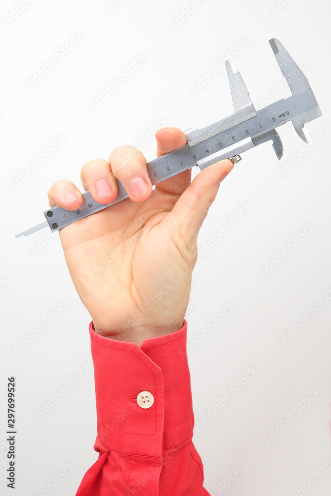 Male hand holds a measuring tool on a white background Male hand holds a measuring tool on a white background