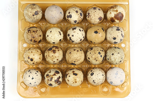 quail eggs in a box close-up on a white background