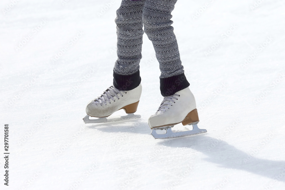 girl skates on ice rink.. Sport and entertainment. Rest and winter holidays. girl skates on ice rink.. Sport and entertainment. Rest and winter holidays.
