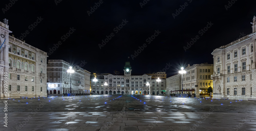 The City Hall, Palazzo del Municipio, is the dominating building on Trieste's main square Piazza dell Unita d Italia. Trieste, Italy, Europe. Illuminated city square shot at night. Long Exposure