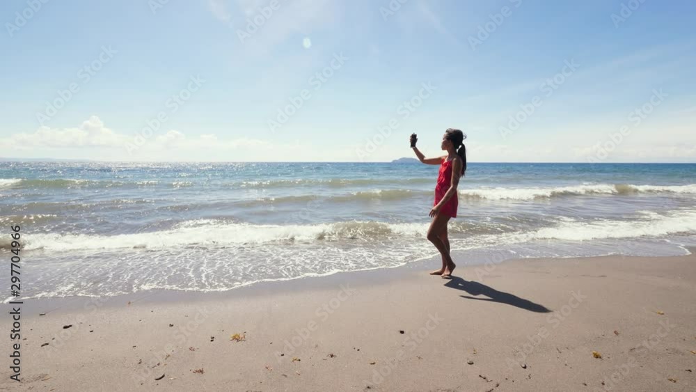 Asian vlogger filming vlog on the beach at summer using smartphone Asian vlogger filming vlog on the beach at summer using smartphone