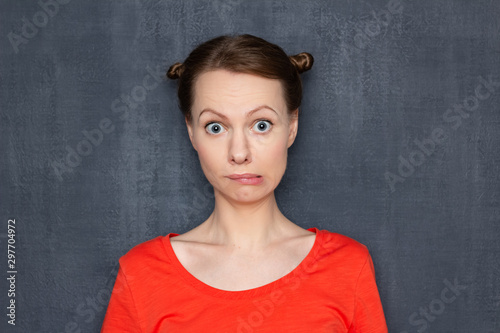 Portrait of surprised perplexed girl looking like stupid user