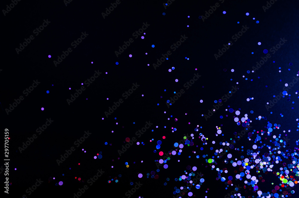 Colorful lights blurred glitter background. Abstract illuminated texture. Christmas, new year or birthday celebration. Night life photography