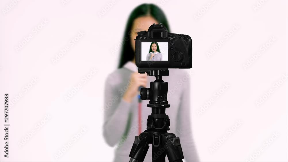 Chinese Asian American teenager with microphone, presentingseen through camera, vlogger concept Chinese Asian American teenager with microphone, presentingseen through camera, vlogger concept