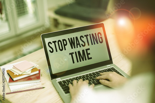 Text sign showing Stop Wasting Time. Business photo showcasing advising demonstrating or group start planning and use it wisely woman laptop computer office supplies technological devices inside home