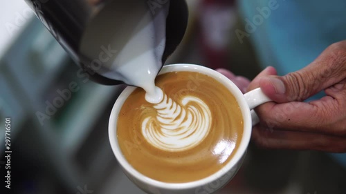 barista pouring milk to make coffee latte art. b-roll footage video 4k. cafe business shop. photo