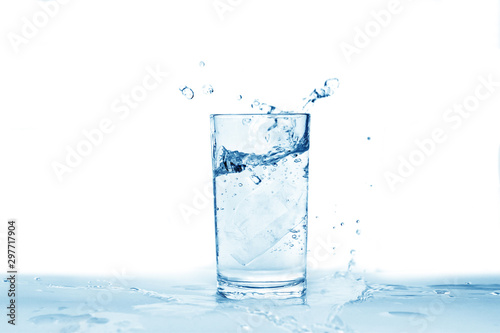 Water splashes in a glass of water isolated white background, copy space 
