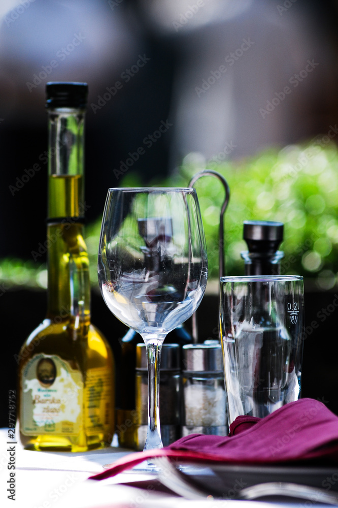 bottle of white wine and two glasses on wooden table