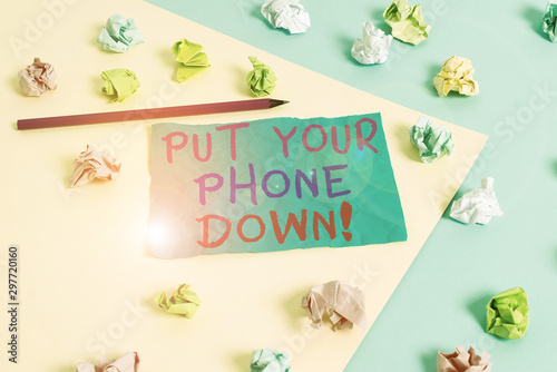 Conceptual hand writing showing Put Your Phone Down. Concept meaning end telephone connection saying goodbye caller Colored crumpled paper empty reminder blue yellow clothespin © Artur