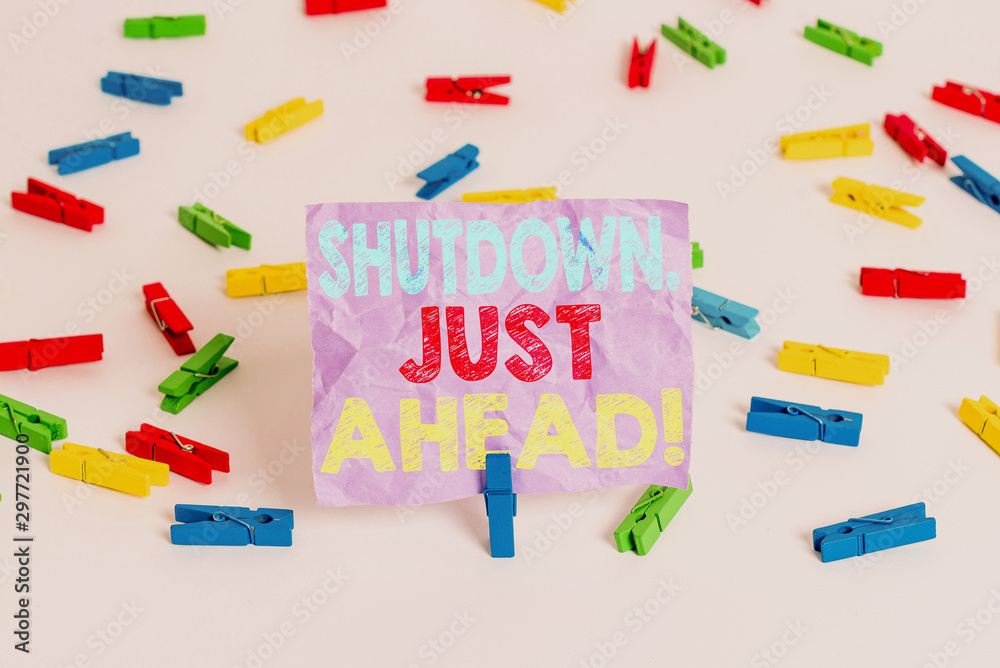 Writing note showing Shutdown Just Ahead. Business concept for closing factory business either short time or forever Colored clothespin papers empty reminder white floor background office Writing note showing Shutdown Just Ahead. Business concept for closing factory business either short time or forever Colored clothespin papers empty reminder white floor background office