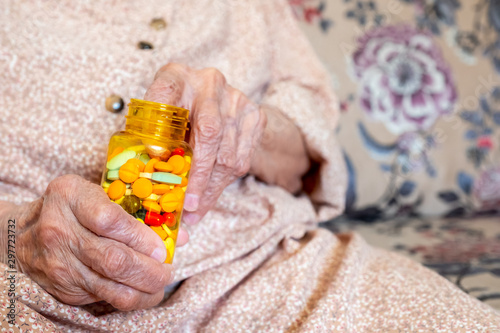 Old woman holding her medicine in her hands