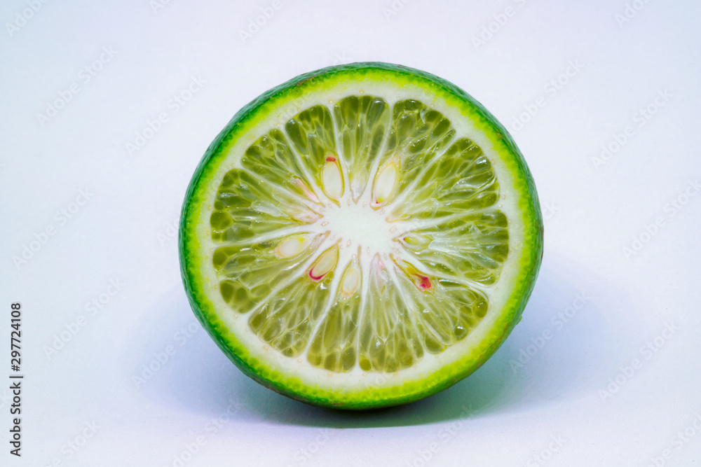A cross section of a small round lime isolated on a white background.