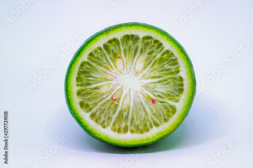 Obraz na płótnie A cross section of a small round lime isolated on a white background. w salonie