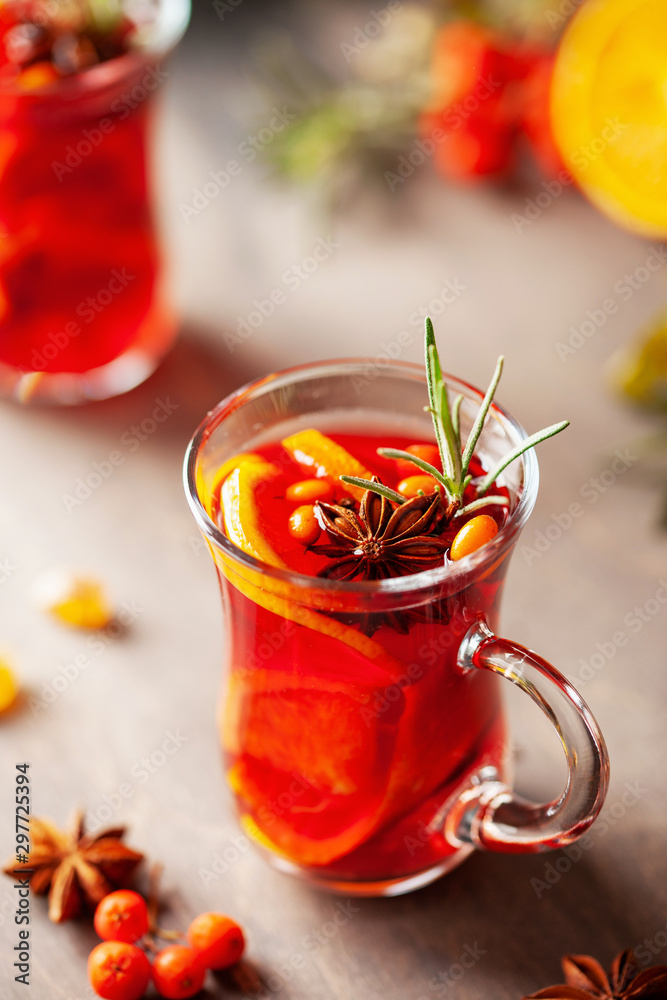 Mulled wine with fruits and spices in glass on a wooden background. Traditional hot drink at Autumn time Mulled wine with fruits and spices in glass on a wooden background. Traditional hot drink at Autumn time
