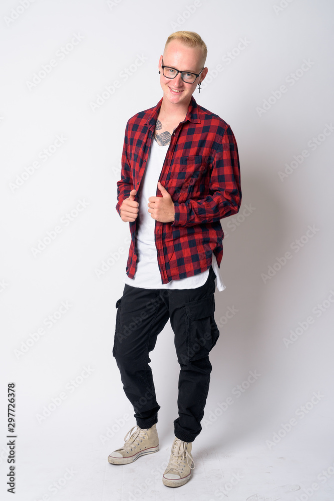 Full body shot of happy young blonde hipster man posing Full body shot of happy young blonde hipster man posing