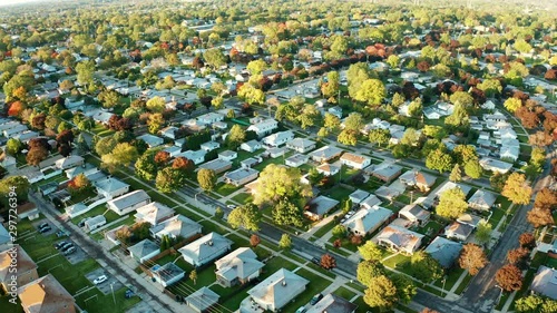 Aerial view of residential houses at autumn (october). American neighborhood, suburb. Real estate, drone shots, sunset, sunny morning,  sunlight, from above