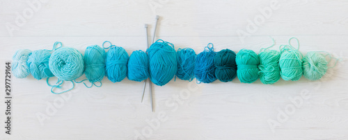 Yarn for knitting aquamarine, green, blue and turquoise colors. White wood long background