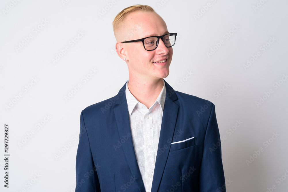 Face of happy young blonde businessman in suit thinking and looking away Face of happy young blonde businessman in suit thinking and looking away