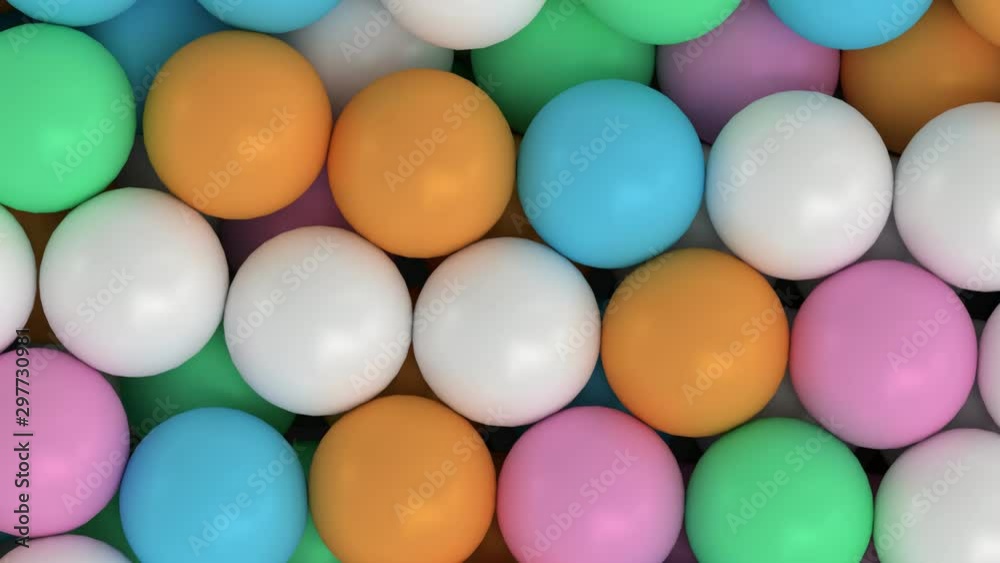 Animated close up top view and flying over pile of a lot of green, pink, blue and orange ping pong or table tennis balls lying in large container or as if moving on conveyor belt. Animated close up top view and flying over pile of a lot of green, pink, blue and orange ping pong or table tennis balls lying in large container or as if moving on conveyor belt.