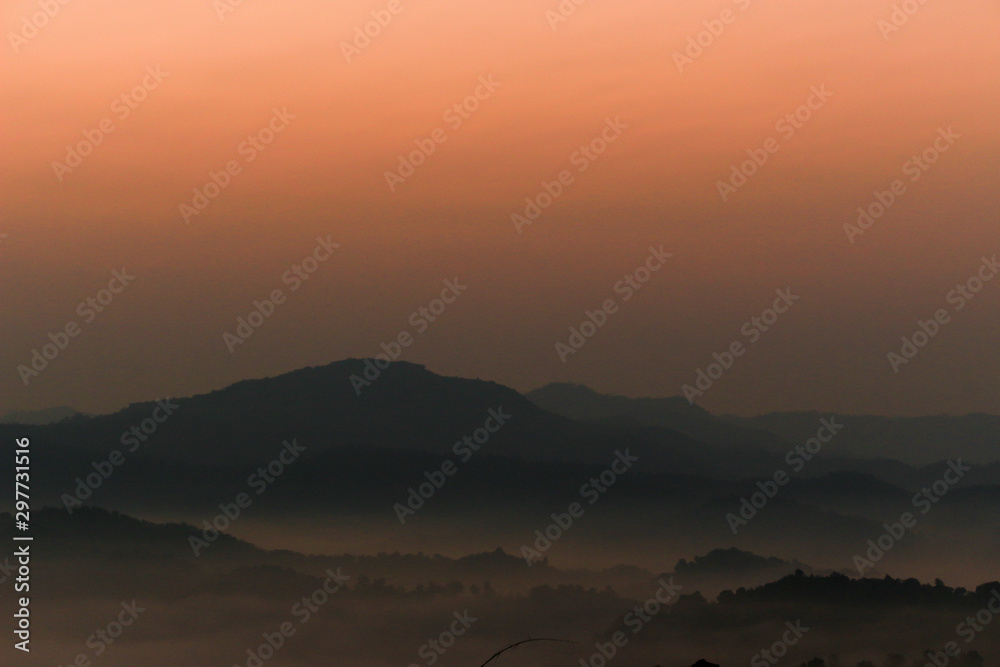 Beautiful scenery of mountain with  mist sea and sunrise sky at view point of Na Ton Chan in the early morning, Si Satchanalai, Sukhothai Province , Thailand.