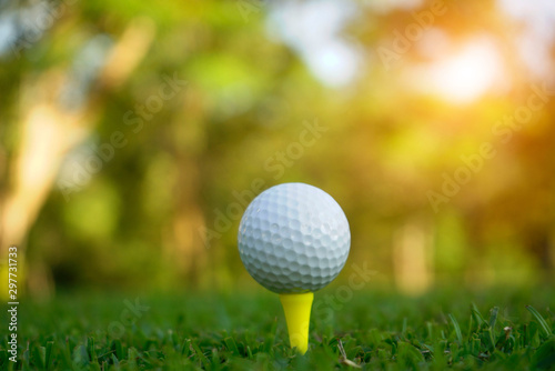 Golf ball on tee in beautiful golf course