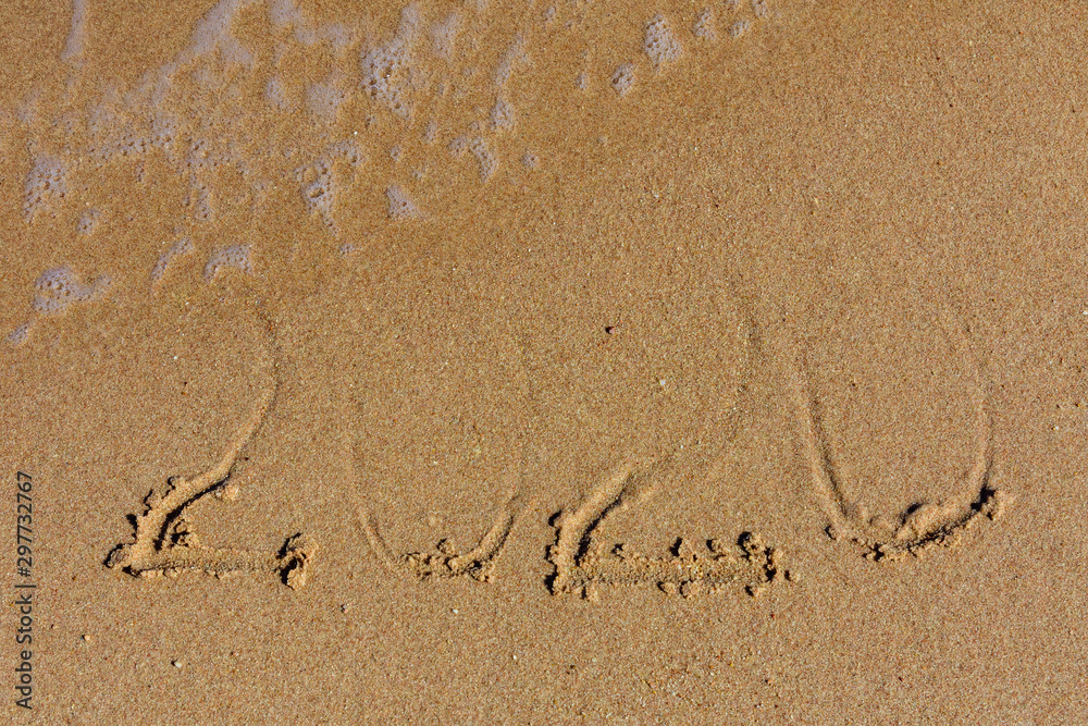 Fototapeta premium New year 2020. Inscription on a sandy beach. Tropical celebration concept