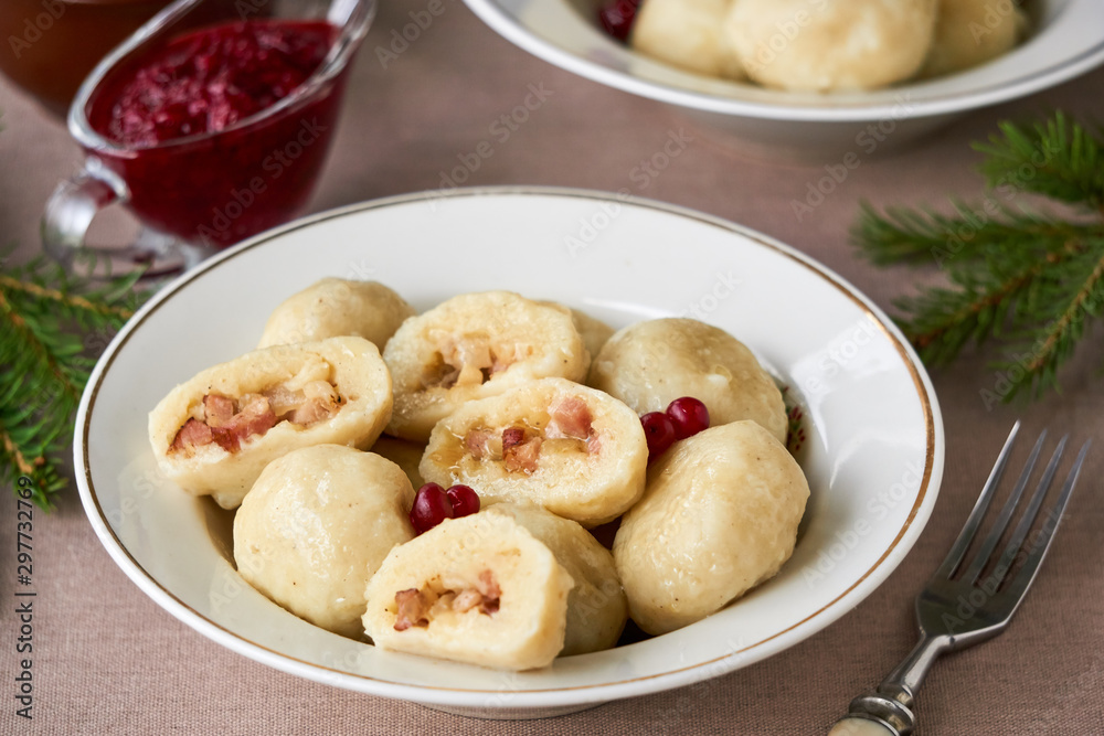 Potato dumplings with fried bacon, onions and lingonberry sauce Potato dumplings with fried bacon, onions and lingonberry sauce