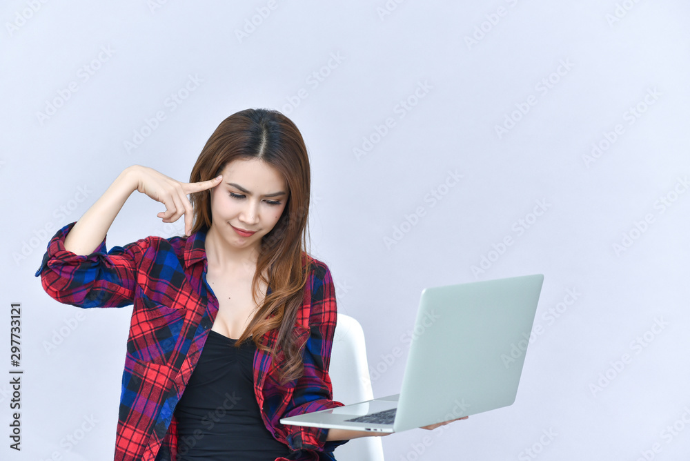 Portrait of a Serious Woman Working on Laptop in her Workplace Portrait of a Serious Woman Working on Laptop in her Workplace
