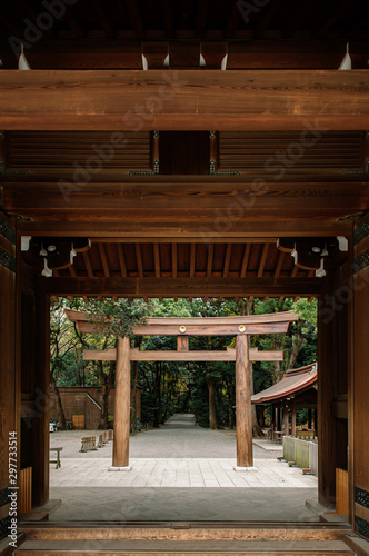 Meiji Jingu Shrine wooden Torii seen through old gate entrance - Tokyo