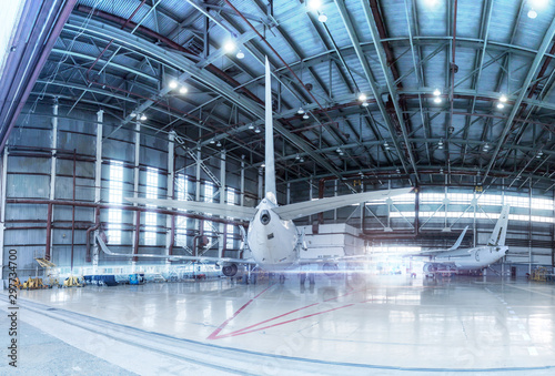Passenger aircrafts under maintenance. Checking mechanical systems for flight operations. Panorama of airplanes in the hangar