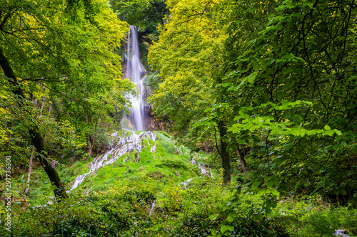 Germany, Amazing tall 37m high waterfall of climatic spa region in green forest of bad urach in swabian jura nature landscape, a tourist attraction for recovering © Simon
