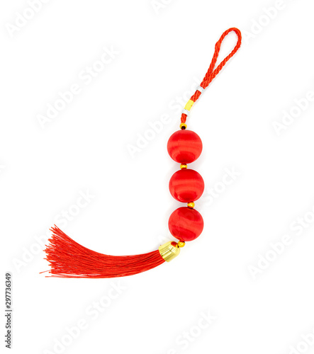 Red knot with tassel, top view photo. Chinese holiday symbol. Red silk knot isolated. Chinese New Year decoration