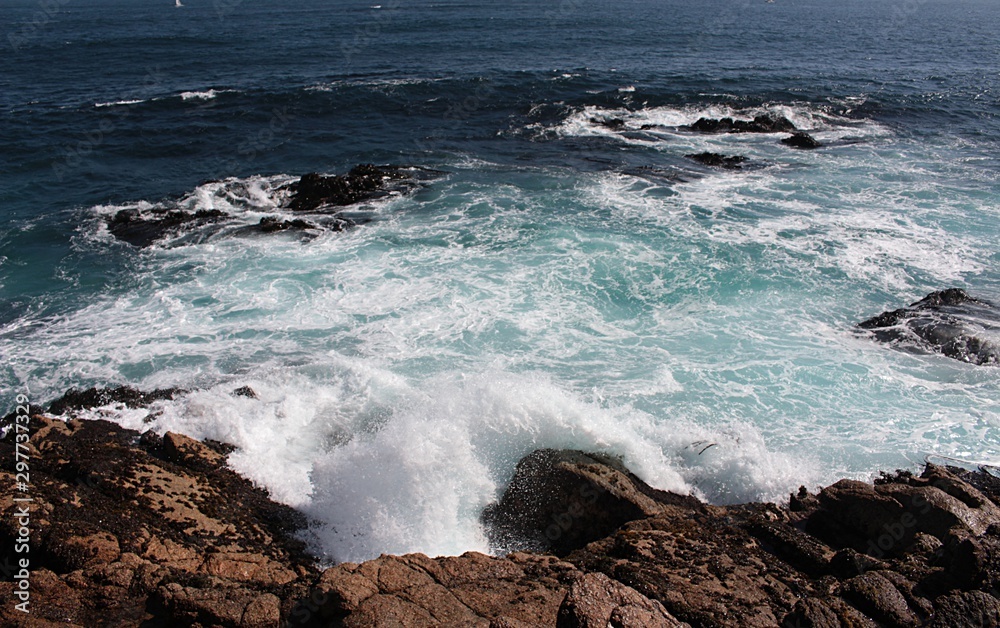 view of sea waves bursting on the rocks in Algarrobo beach in Chile