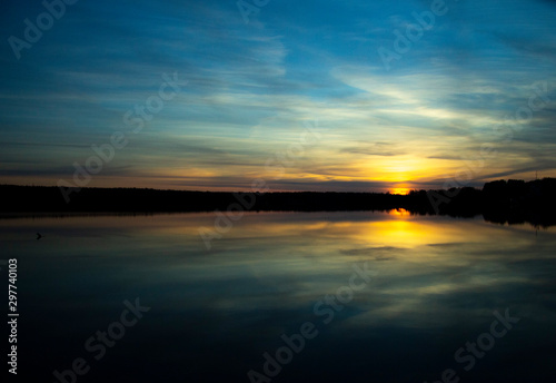 Beautiful sunset reflected in the lake. Scenic landscape © andreysha74