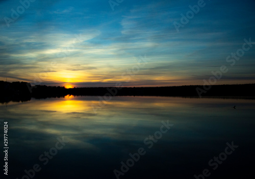 Beautiful sunset reflected in the lake. Scenic landscape
