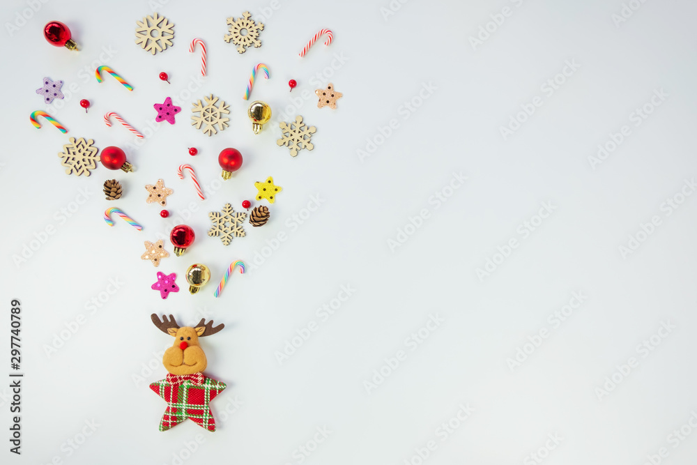 Christmas background concept.Top view of reindeer splash out christmas decoration with candy cane, snowflake, star and colorful ball on white background with copy space for text.