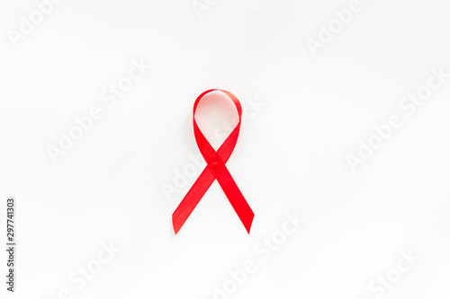 AIDS disease. Red ribbon on white background top view space for text