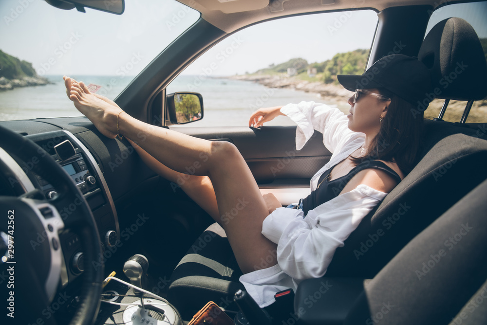 woman sitting in car show sexy legs looking at summer sea beach Stock Photo  | Adobe Stock