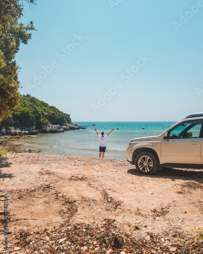 car travel concept man at summer beach looking at sea © phpetrunina14