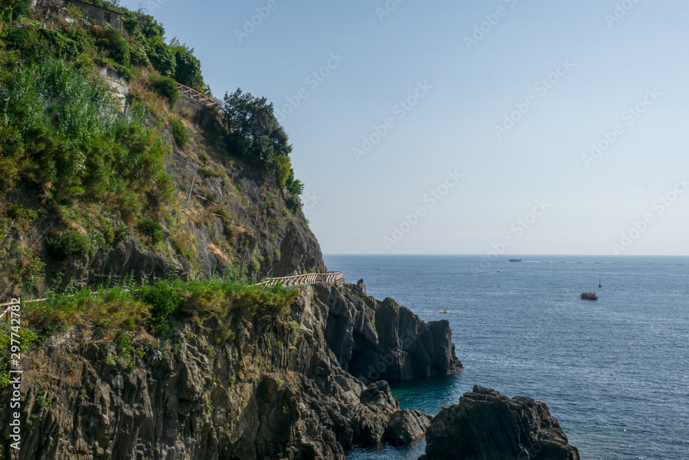 Riomaggiore Cliffs over the blue sea, Cinque Terre, La Spezia, Italy