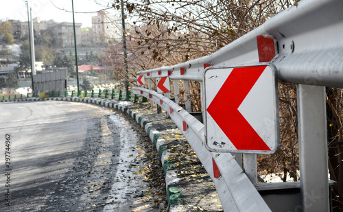 Traffic sign on gaurdrail photo