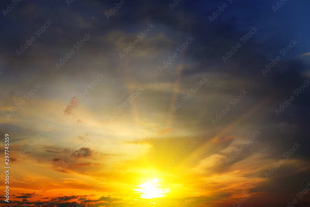 Dramatic sunset with bright rays and dark clouds