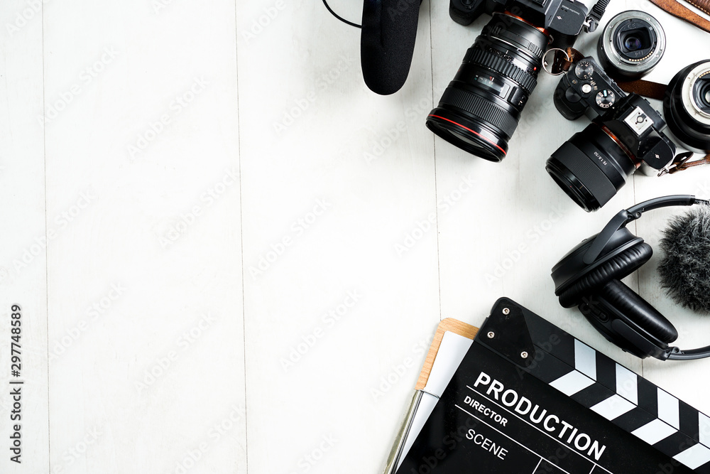 Camping or adventure trip scenery concept. Backpack, boots, belt, thermos and camera on wooden background captured from above (flat lay). Layout with free text (copy) space.