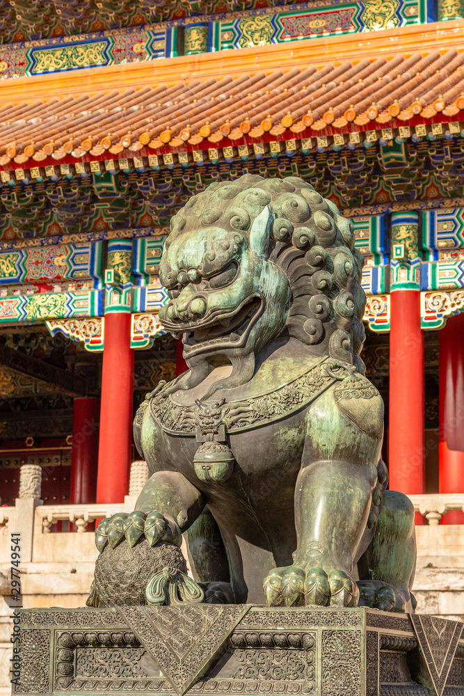 Chinese guardian lion or shishi statue from Ming dynasty era, at the entrance to the palace in the Forbidden City, Beijing, China