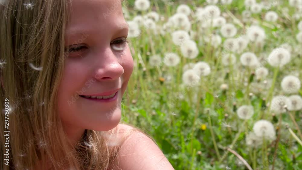 Smiling Girl and Dandelions. Happy girl on a dandelions among flying fluffy seeds. Slow Motion 120 fps Smiling Girl and Dandelions. Happy girl on a dandelions among flying fluffy seeds. Slow Motion 120 fps