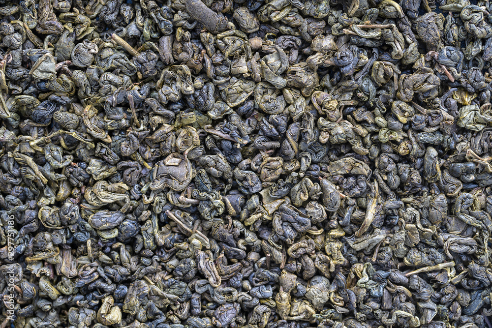 Green tea leaves background. Oolong tea. Abstract food textures. Close up .The high end tea of China. Green tea leaves background. Oolong tea. Abstract food textures. Close up .The high end tea of China.