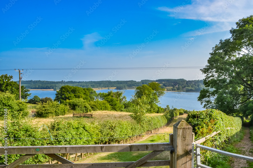 View over a gate towards Rutland Water a large reservoir in Leicestershire
