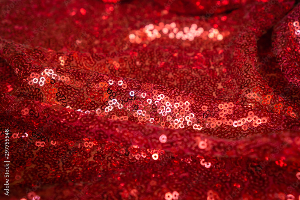 Red glittering background of fabric and sequins Red glittering background of fabric and sequins