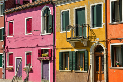Colorful houses on Fondamenta Pontinello Destra street in quiet part of Burano village close to Venice photo
